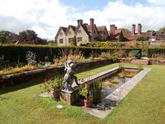 Packwood House with a fountain, gardens, and house