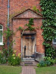 historical door with black metal gate at Packwood House