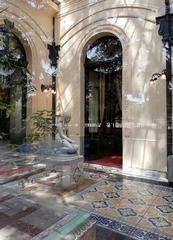 Winter garden of Palacio Cousiño with Italian tile flooring and marble sculpture 'Eva después del pecado' by Pietro Bernasconi