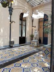 Winter garden of the Palacio Cousiño with Italian majolica floor and La Mignon marble sculpture by Pietro Calvi