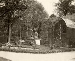 Buddha statue near aviary at Artis Zoo in Amsterdam, 1918