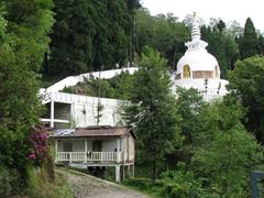 Japanese Peace Pagoda in Darjeeling with stilted house in foreground