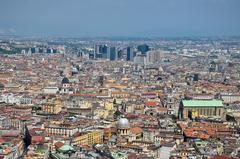 a narrow old street filled with people and colorful buildings in Naples, Italy