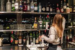 waitress sorting bottles in a Zurich bar