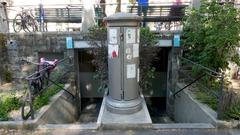 Public WC at Place du Bourg-de-Four in Geneva with a PTT column between two staircases