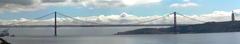 Panoramic view of 25 de Abril Bridge and Christ the King statue in Lisbon