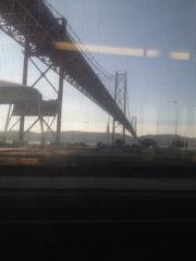 View of Christ the King statue and 25 de Abril Bridge in Lisbon