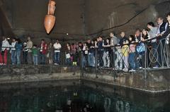 Ancient water well with a hanging amphora in Napoli Sotterranea