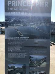 Information board about Princess Pier in Port Melbourne, Australia, titled 'A forest of piles,' featuring historical photos and diagrams