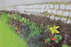 Broad Boundary with cobblestones and flower beds