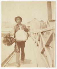 Chimney sweep walking across Pyrmont Bridge, Sydney, ca. 1885-1890