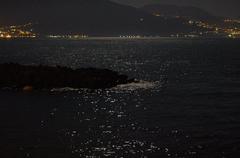 Moonlit reflections on the Gulf of Naples at nighttime in Torre del Greco, Italy