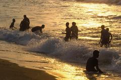 youngsters silhouetted by morning sun at RK beach