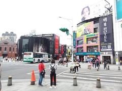 Ximen Red House octagonal building with buses, Tomorrow Hotel, and shops