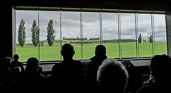 Visitors to Fort McHenry standing for the National Anthem with the Star Spangled Banner in the background