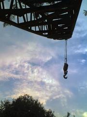 a dramatic scene where a person hangs onto an outstretched arm seemingly from the sky