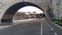 Fiume Tevere river in Rome with ancient bridge and buildings in the background