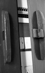 Old wooden door with modern electrical consumer unit inside