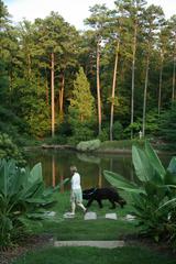 woman walking her dog at Sarah P. Duke Gardens