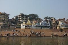 Scindia Ghat in Varanasi with boats and people along the Ganges River