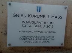 Commemoration of Ġnien Mass with participants holding banners