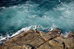 Man rock fishing in Sydney Harbour National Park near Shelly Beach, Manly