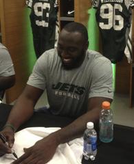 Muhammad Wilkerson signing autographs at MetLife Stadium locker room