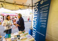 FEMA representative speaking with a visitor at New Jersey State Fair about flood insurance benefits