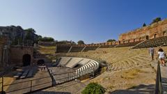 panoramic view of Taormina, Italy with mountains in the background