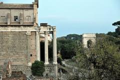 Temple of Antoninus and Faustina with the Arch of Titus in Rome