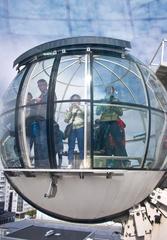 glass gondola ascending outside of Globe