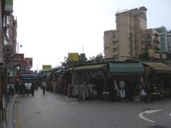 Scenic view of Stanley Market in Hong Kong featuring colorful stalls and lush greenery