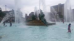 children playing in Swann Memorial Fountain 4th of July