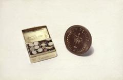 World's smallest medicine chest in Queen Mary's doll house compared to a half penny