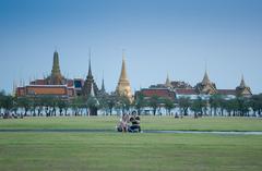 couple kiting at Sanam Luang with Wat Phra Kaew and Grand Palace in background