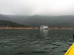 view of Tai Tam Harbour with hills and a bridge in the background