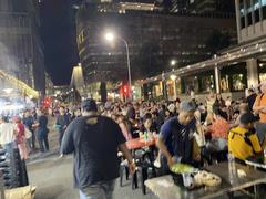 Night view of Lau Pa Sat festival market in Singapore with city skyscrapers in the background