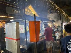 Lau Pa Sat night market with illuminated booths and people