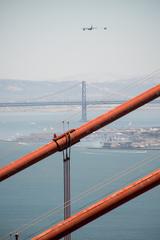 U.S. Air National Guard HC-130J Combat King II aircraft and two HH-60G Pave Hawk helicopters in flight over the San Francisco Bay Area