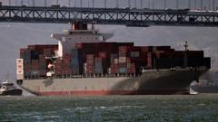 K-Line cargo ship with San Francisco - Oakland Bay Bridge in the background