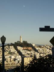 Coit Memorial Tower with moon and Bay Bridge