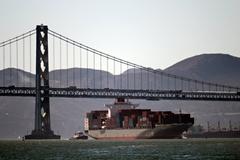 K-Line cargo ship with San Francisco - Oakland Bay Bridge in background