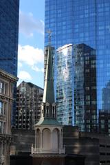 Close up of Old South Meeting House spire with modern buildings in the background