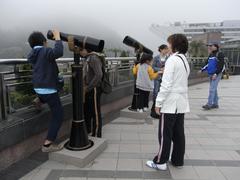 Visitors on the rooftop of Peak Galleria in Hong Kong on a foggy day