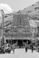 Historical rock-cut temple with towering rajagopuram and granite hill in the background