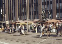 Pedestrians at Kolmen sepän square and tram stop, Felix Nylund statue, 1932