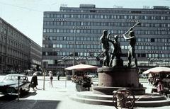 Mannerheimintie street view with the Three Blacksmiths statue in the foreground