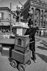 street musician playing barrel organ at a public square event in Helsinki