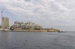 Beautiful landscape of Malta featuring a mix of traditional architecture and modern structures with a blue sky overhead