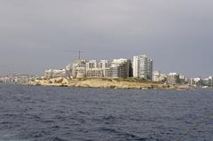 Scenic view of Malta's coastline with blue sea and historic buildings